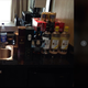 A hotel room kitchen counter stocked with alcohol and drink mixers.